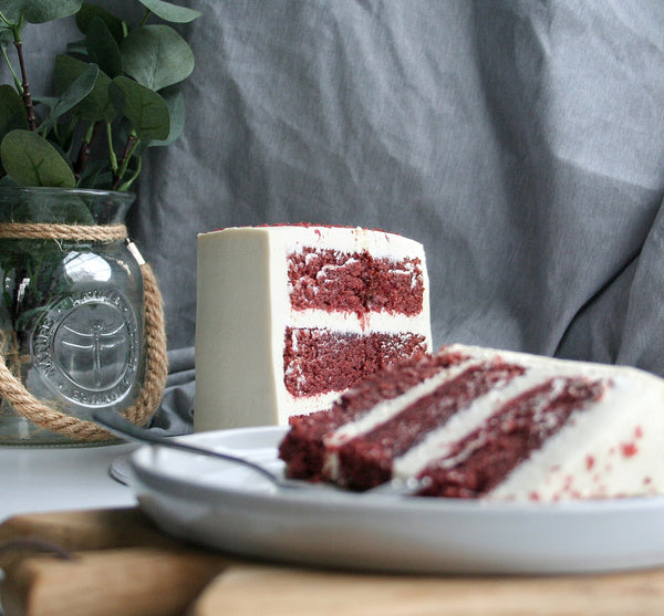 Red Velvet cake slice with cake in background